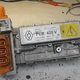A power module from a Renault Zoe, containing charging circuitry as well as the DC/DC converter. These go by different names depending on the car and manufacturer. Note the water cooling inlet on the right.